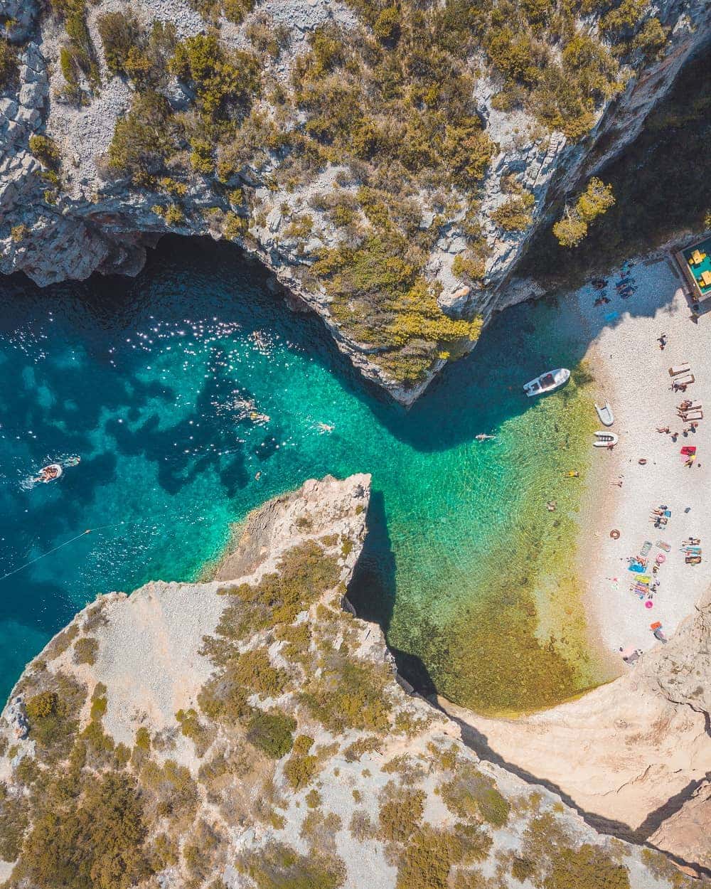 Stiniva Cove on Vis island surrounded by steep limestone cliffs