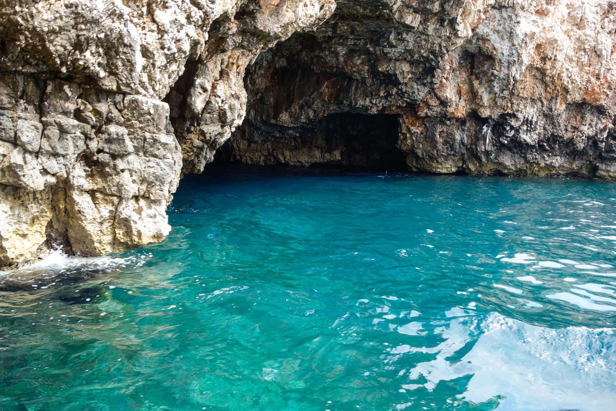 Swimming inside the Green Cave near Ravnik island Croatia