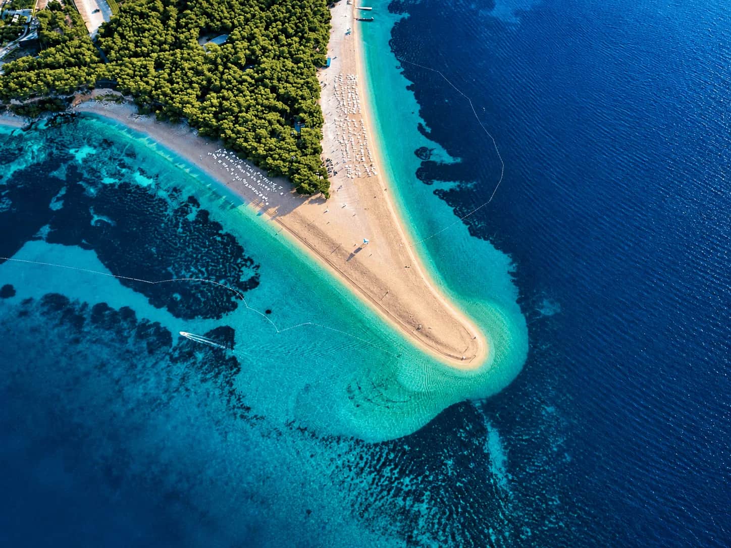 Aerial view of Zlatni Rat Beach on Brac Island, Croatia, with turquoise Adriatic waters, pine forest and the pebble spit